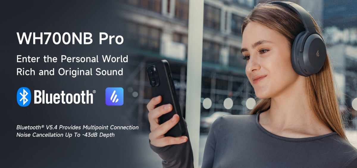 Woman wearing Edifier WH700NB Pro wireless noise cancelling headphones while using a phone